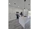 Bright kitchen boasts quartz counters, stainless appliances, a large island and stylish gray wood-look floors at 3519 Sw 131St Place St, Ocala, FL 34473