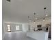 Open kitchen features stainless appliances, a center island and hanging pendant lights at 3519 Sw 131St Place St, Ocala, FL 34473