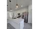 Modern kitchen features stainless appliances, white cabinets and quartz counters at 3519 Sw 131St Place St, Ocala, FL 34473