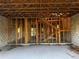 Unfinished interior with wood framing, block walls, wood ceiling beams and a staircase visible at 3627 Lincoln St, Sanford, FL 32771