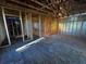 Unfinished interior room framed and ready for design, featuring plywood flooring and exposed beam ceiling at 3627 Lincoln St, Sanford, FL 32771