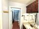Hallway bathroom view showcasing vanity with granite and shower with glass doors at 417 Rio Grande Ct, Kissimmee, FL 34759