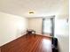 Bedroom with wood floors, a table, and a window with patterned curtains at 417 Rio Grande Ct, Kissimmee, FL 34759