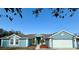 Charming single-story home featuring a well-manicured lawn and attached two-car garage at 417 Rio Grande Ct, Kissimmee, FL 34759