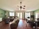 Spacious living room featuring hardwood floors, a ceiling fan, and a comfortable sectional sofa at 417 Rio Grande Ct, Kissimmee, FL 34759