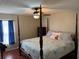 Comfortable main bedroom with a four-poster bed, ceiling fan, and a large window at 417 Rio Grande Ct, Kissimmee, FL 34759