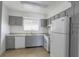 Bright kitchen with granite countertops, stainless steel sink and gray cabinets at 4205 S Semoran Blvd # 3, Orlando, FL 32822