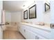 Bathroom featuring double sinks, a tub, white cabinets, and marble countertops at 5258 Tunbridge Wells Ln # 1902, Orlando, FL 32812