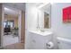 Bathroom featuring a white vanity and a mirror, with a glimpse into the adjacent office space at 5258 Tunbridge Wells Ln # 1902, Orlando, FL 32812