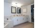 Bathroom showcasing double sinks, a bath tub, white cabinets, and marble countertops at 5258 Tunbridge Wells Ln # 1902, Orlando, FL 32812