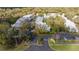 Aerial view of a condominium community showcasing mature trees, manicured lawns and ample parking at 5258 Tunbridge Wells Ln # 1902, Orlando, FL 32812