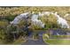 Aerial view of a condominium community showcasing mature trees, manicured lawns and ample parking at 5258 Tunbridge Wells Ln # 1902, Orlando, FL 32812