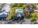 Aerial view of a community pool and clubhouse surrounded by mature trees and parking in a condominium complex at 5258 Tunbridge Wells Ln # 1902, Orlando, FL 32812