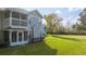 Exterior of condo building showcasing a porch and a large lawn at 5258 Tunbridge Wells Ln # 1902, Orlando, FL 32812