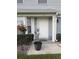 Charming home exterior with a well-maintained yard, potted plants, and a welcoming front door at 5258 Tunbridge Wells Ln # 1902, Orlando, FL 32812