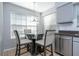 Cozy breakfast nook featuring a glass table, seating for four, and natural light from large windows at 5258 Tunbridge Wells Ln # 1902, Orlando, FL 32812