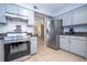 Well-lit kitchen boasts stainless steel appliances, gray cabinets, and easy access to living spaces at 5258 Tunbridge Wells Ln # 1902, Orlando, FL 32812
