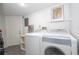 Clean laundry room equipped with a washer, dryer, and additional storage options at 5258 Tunbridge Wells Ln # 1902, Orlando, FL 32812