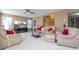 Bright living room featuring neutral tones, plush sofas, and a large screen television at 5258 Tunbridge Wells Ln # 1902, Orlando, FL 32812