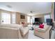 Cozy living room with comfortable furniture, a ceiling fan, and plenty of natural light at 5258 Tunbridge Wells Ln # 1902, Orlando, FL 32812