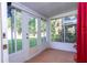Enclosed lanai with many windows and doors to the outside, with tile floor and white walls at 5258 Tunbridge Wells Ln # 1902, Orlando, FL 32812
