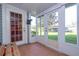 Enclosed sunroom with multiple windows and doors leading to the backyard, featuring a tile floor at 5258 Tunbridge Wells Ln # 1902, Orlando, FL 32812