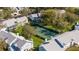 Aerial view of a green tennis court surrounded by condos and lush green trees in a well maintained community at 5258 Tunbridge Wells Ln # 1902, Orlando, FL 32812