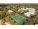 Aerial view of two tennis courts surrounded by mature landscaping and condominiums in a quiet community at 5258 Tunbridge Wells Ln # 1902, Orlando, FL 32812