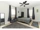 Neutral bedroom features simple furnishings with a ceiling fan and window at 558 Tyler Ave, Deltona, FL 32725