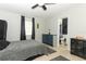 Minimalist bedroom with neutral walls, a simple window, ceiling fan and bathroom access at 558 Tyler Ave, Deltona, FL 32725