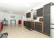 Bright and spacious kitchen featuring stainless steel appliances and stylish black cabinets at 558 Tyler Ave, Deltona, FL 32725