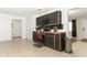 Well-lit kitchen showcasing modern black cabinets and tile flooring with laundry room at 558 Tyler Ave, Deltona, FL 32725