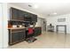 Well-lit kitchen featuring black cabinets, tile backsplash, and stainless steel appliances at 558 Tyler Ave, Deltona, FL 32725