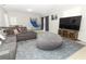 Cozy living room features a large television, comfortable sofa and oversized beanbag at 558 Tyler Ave, Deltona, FL 32725