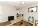 Inviting living room featuring neutral walls, ceiling fan, and decorative rug on ceramic tile floors at 558 Tyler Ave, Deltona, FL 32725