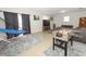 Spacious living room with tile flooring, gray sofa, and a foosball table at 558 Tyler Ave, Deltona, FL 32725