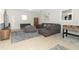 Open-concept living room with neutral gray color scheme, comfortable seating, and tile flooring at 558 Tyler Ave, Deltona, FL 32725
