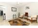 Comfortable living room featuring neutral walls, tile flooring, two chairs, and a decorative rug at 558 Tyler Ave, Deltona, FL 32725