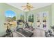 Bright exercise room features ample windows and various fitness equipment, perfect for a home gym at 6005 Bancroft Blvd, Orlando, FL 32833