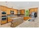 Gourmet kitchen with custom cabinets, granite countertops, stainless steel appliances, and a center island at 6005 Bancroft Blvd, Orlando, FL 32833