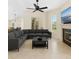 Spacious living room featuring a modern sectional sofa, fireplace, and large windows for natural light at 6005 Bancroft Blvd, Orlando, FL 32833