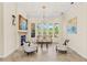 Bright and elegant living room featuring neutral colors, fireplace, decorative molding, and large windows at 6005 Bancroft Blvd, Orlando, FL 32833