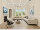 Bright living room featuring tray ceilings, large windows, and modern decor at 6005 Bancroft Blvd, Orlando, FL 32833