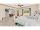 Bright main bedroom has a ceiling fan, views of the landscaped backyard and an entrance to the ensuite bathroom at 6005 Bancroft Blvd, Orlando, FL 32833