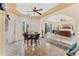 Bright main bedroom boasts an attached sitting room, ceiling fan, and views of the landscaped backyard at 6005 Bancroft Blvd, Orlando, FL 32833