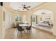 Bright main bedroom boasts an attached sitting room, ceiling fan, and views of the landscaped backyard at 6005 Bancroft Blvd, Orlando, FL 32833