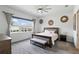 Bright bedroom with large window, neutral decor, and comfortable furnishings creating a relaxing retreat at 6117 Sandy Springs Ct, St Cloud, FL 34771