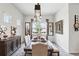 Elegant dining room featuring a decorative light fixture, a dining table, and stylish wall art at 6117 Sandy Springs Ct, St Cloud, FL 34771