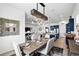 Open concept dining area adjacent to a modern kitchen and living space, perfect for entertaining at 6117 Sandy Springs Ct, St Cloud, FL 34771