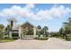 Community gatehouse with manicured landscaping, showing the entrance to the Hammock Club at 6117 Sandy Springs Ct, St Cloud, FL 34771